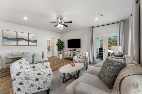 Bright open kitchen and dining area with white cabinets